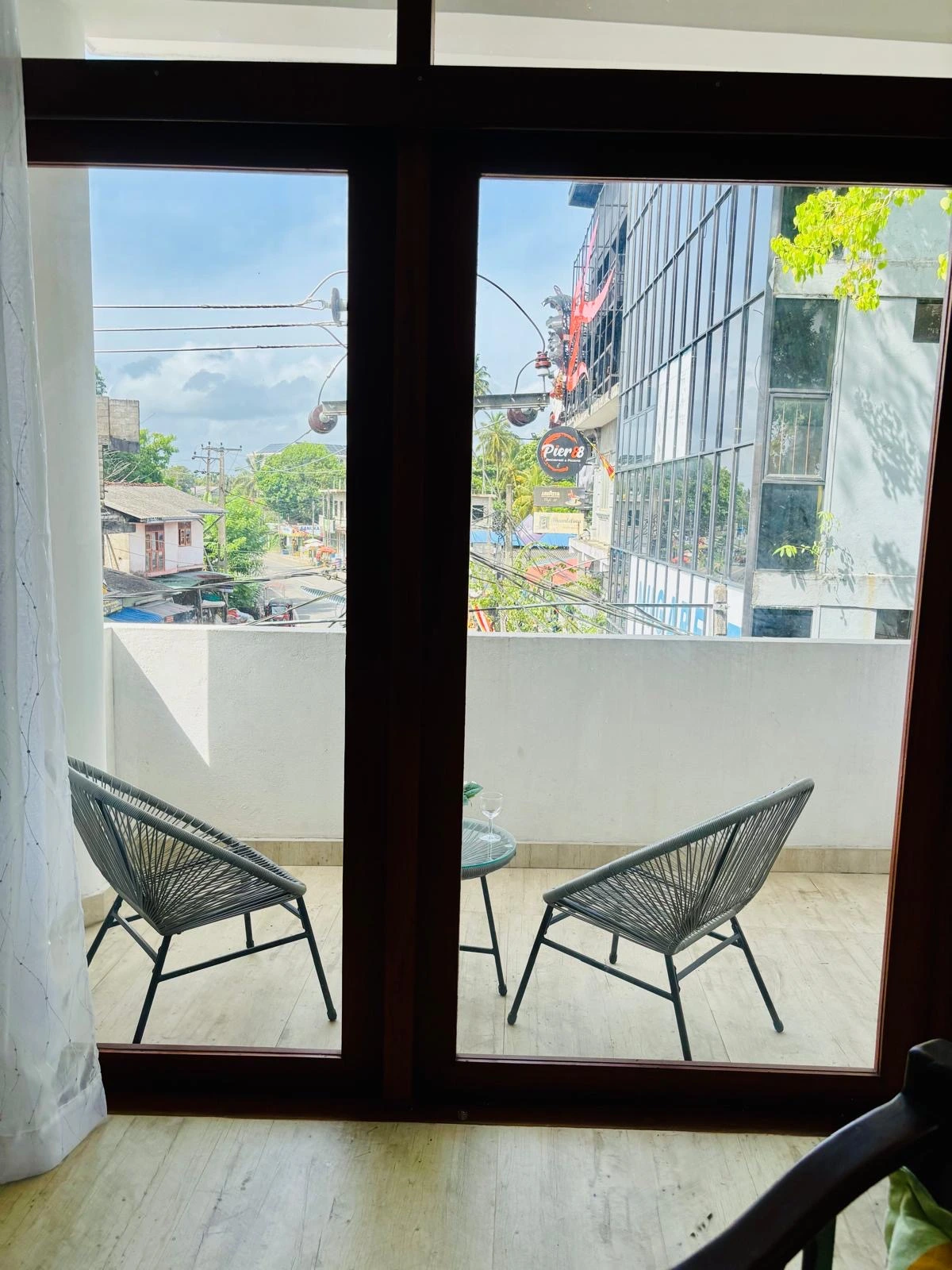 Balcony with wooden sun loungers and tree view