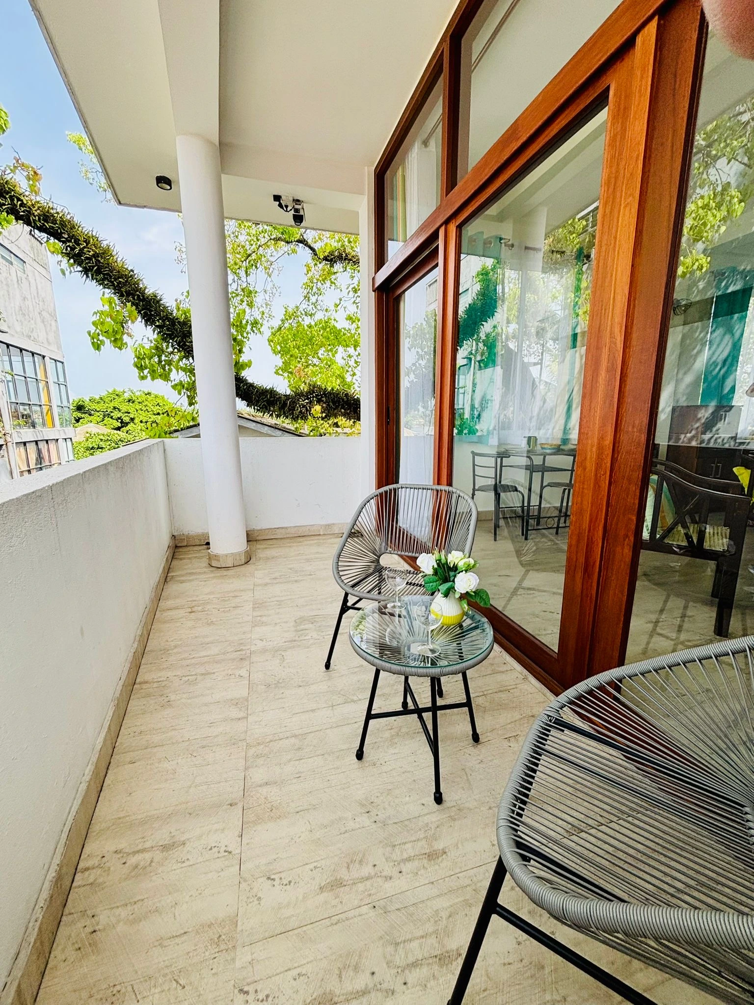 Balcony with wooden sun loungers and tree view