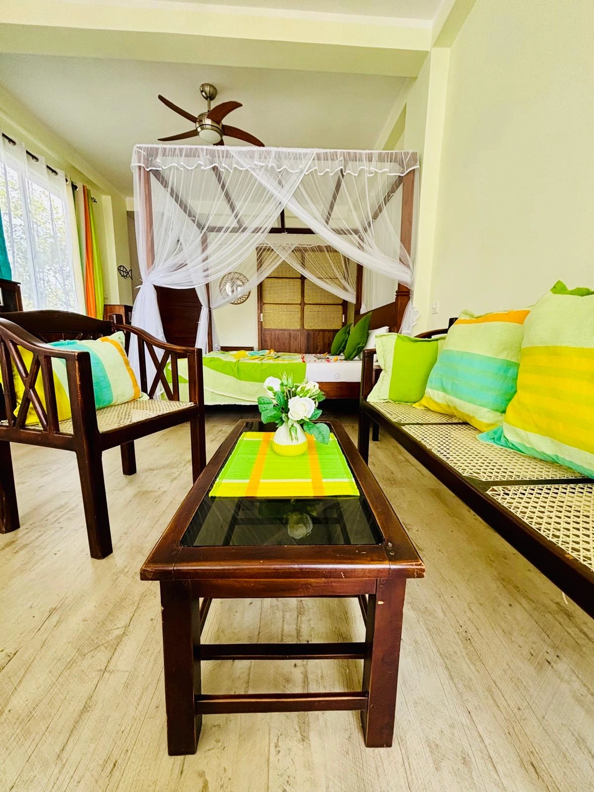 Living room with canopy bed and tropical decor