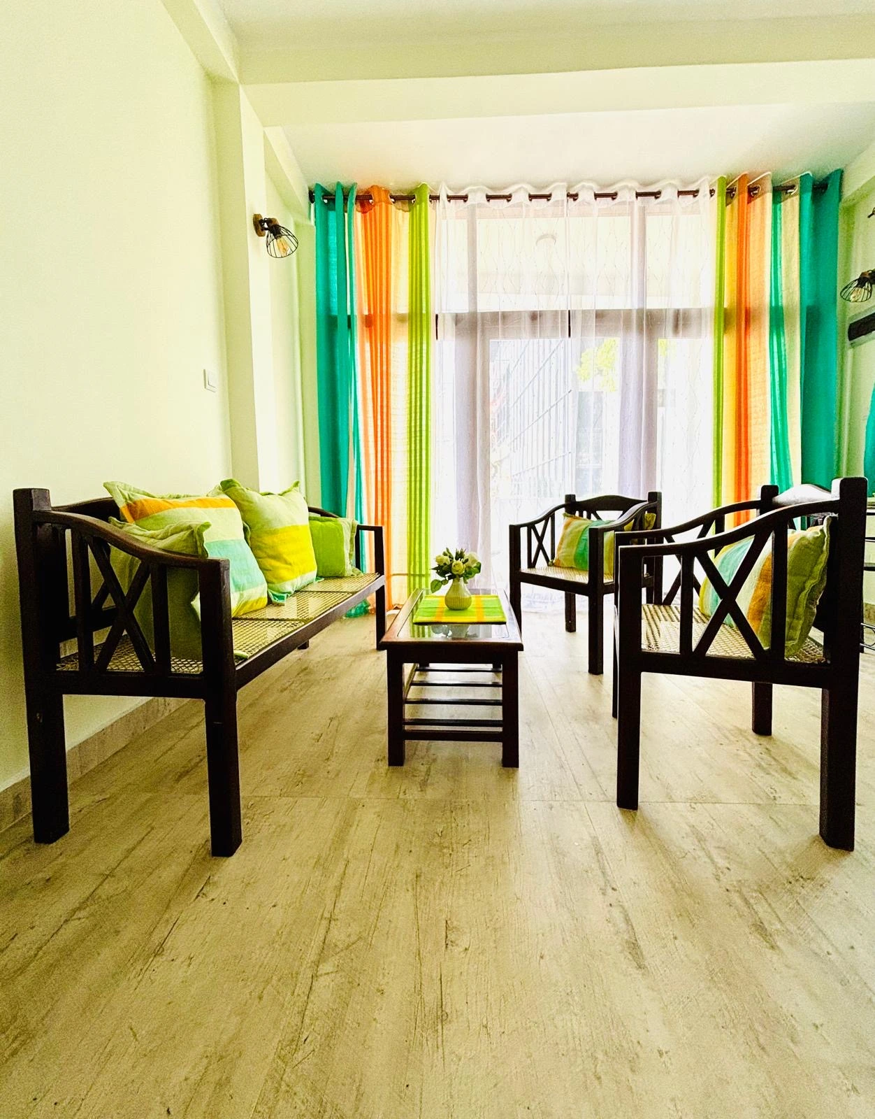 Bedroom with colorful Sri Lankan flag-themed bedding
