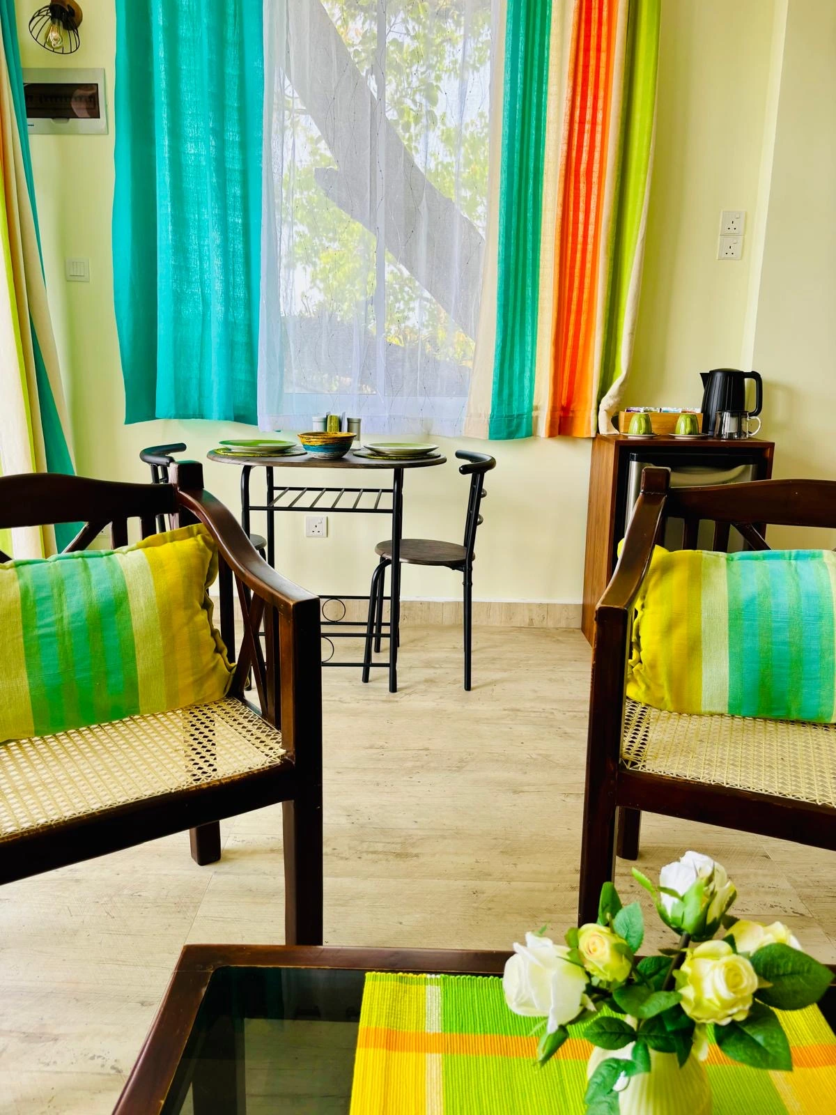 Bedroom with colorful Sri Lankan flag-themed bedding